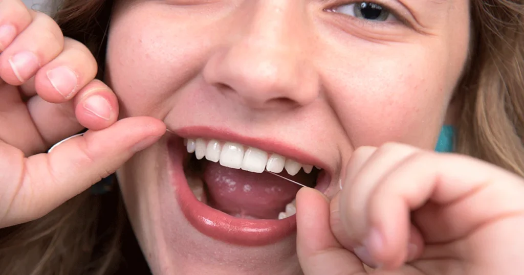 A picture of a lady flossing 101