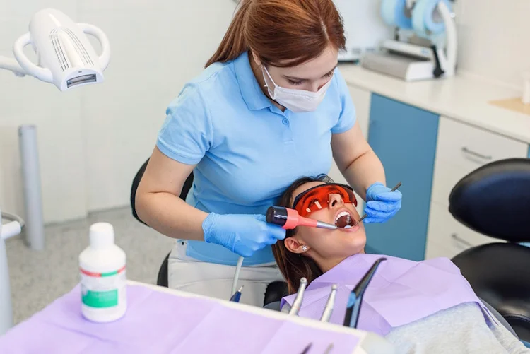 A picture of a woman getting her teeth cleaned