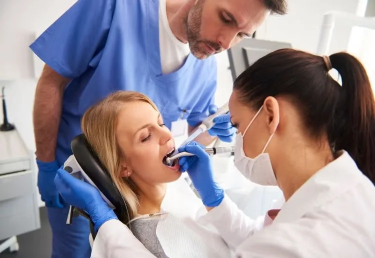 A picture of a woman in the middle of dental work
